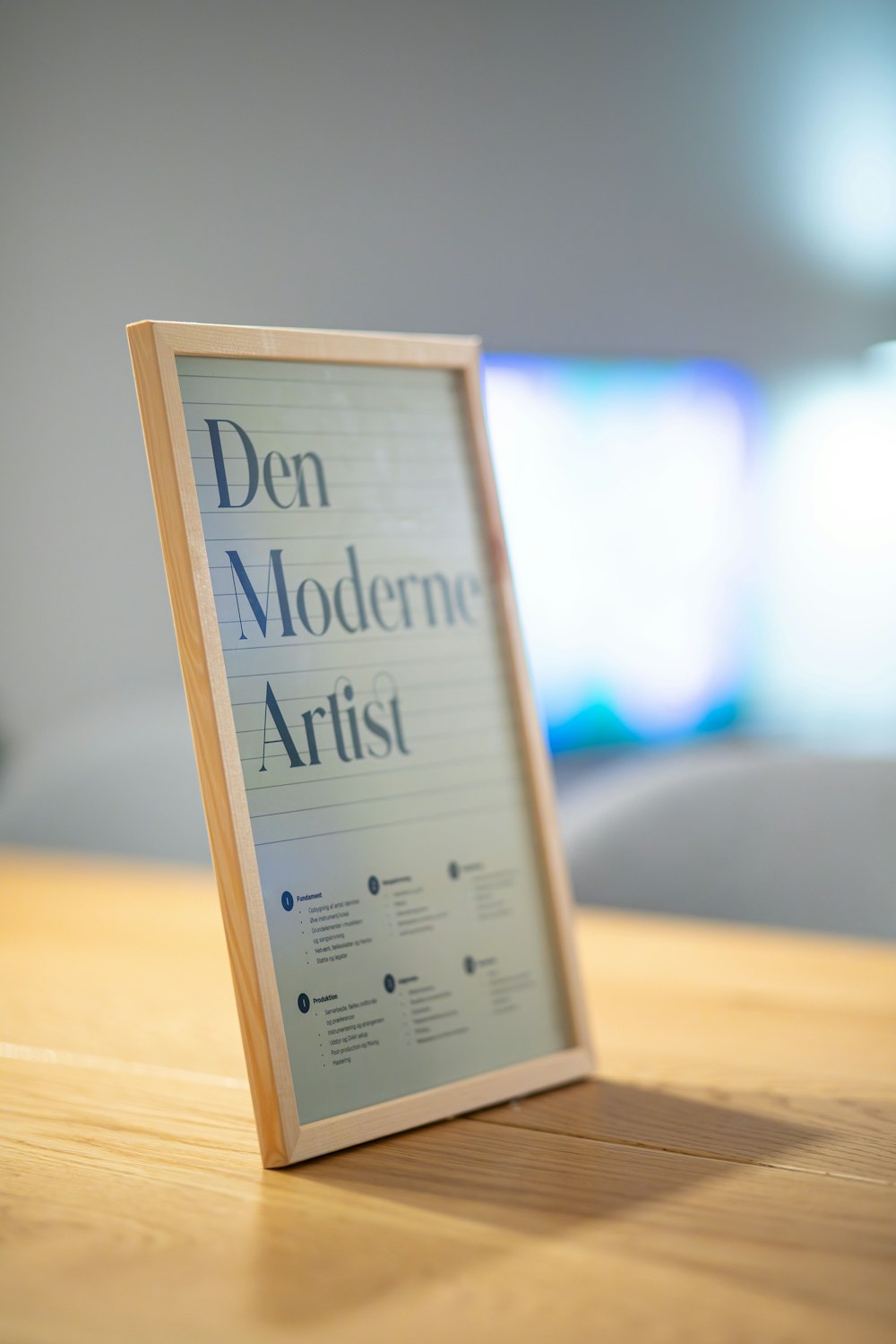 a picture frame sitting on top of a wooden table