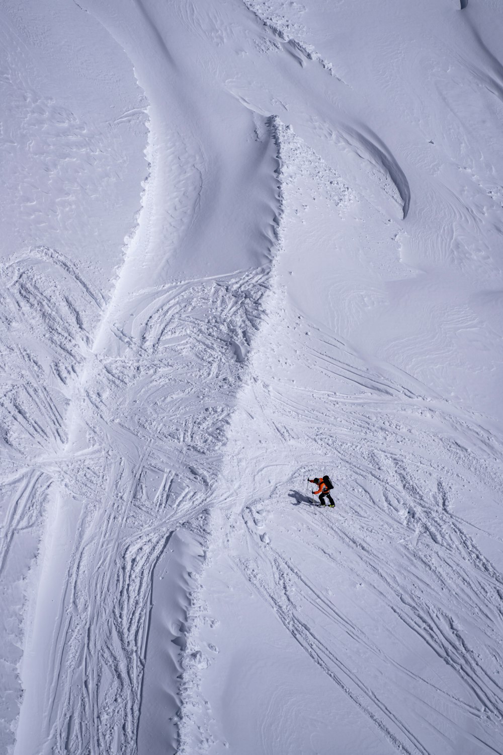 a person riding skis down a snow covered slope