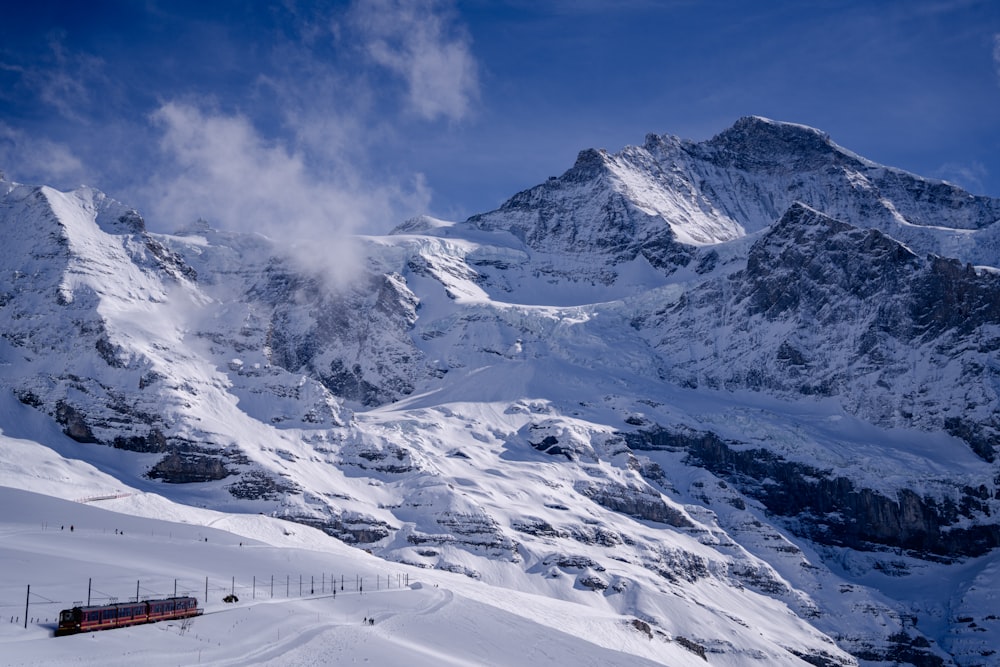 a train traveling down a snow covered mountain side