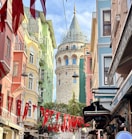 a city street with a tower in the background