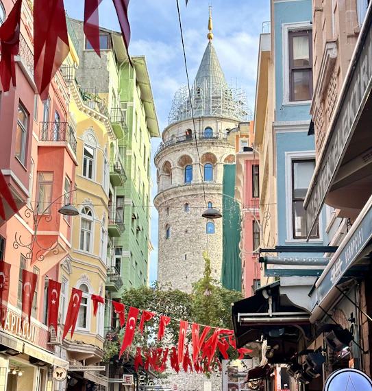 a city street with a tower in the background