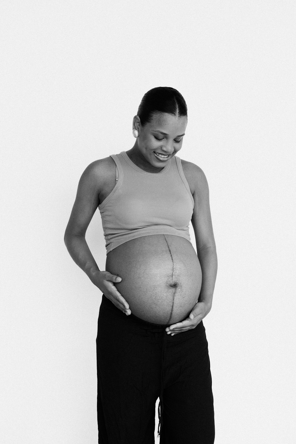 a pregnant woman holding her belly in her hands