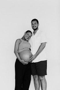 a man and woman pose for a black and white photo