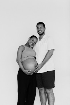 a man and woman pose for a black and white photo
