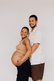 a pregnant man and woman pose for a picture