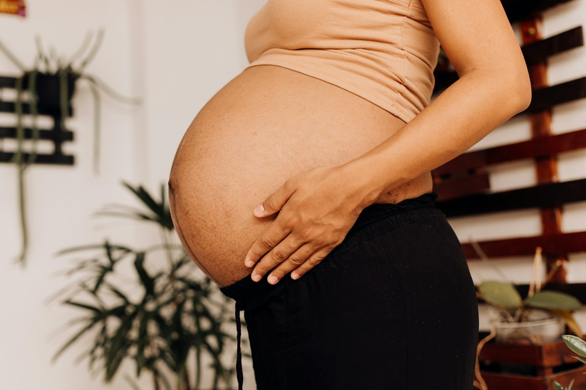 a pregnant woman holding her belly in her hands