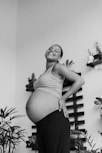 a black and white photo of a pregnant woman
