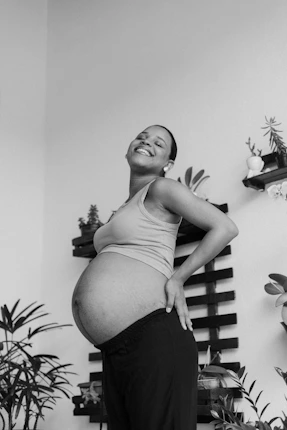 a black and white photo of a pregnant woman
