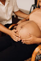 a pregnant woman is sitting in a chair