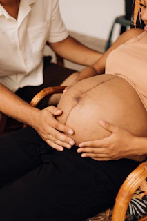 a pregnant woman is sitting in a chair