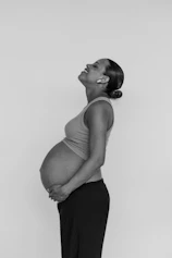 a black and white photo of a pregnant woman