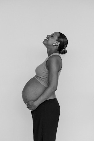 a black and white photo of a pregnant woman