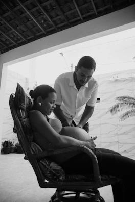 a man and a woman sitting in a chair