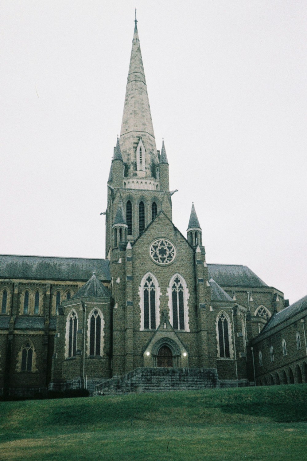 a large church with a steeple and a clock on it