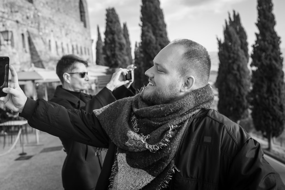 a black and white photo of a man taking a picture