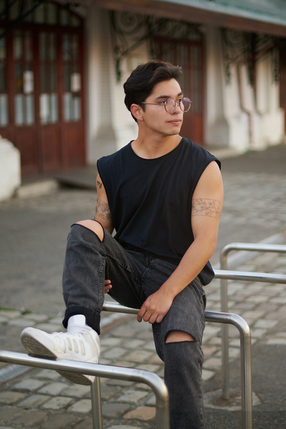 a man sitting on a bench with his legs crossed