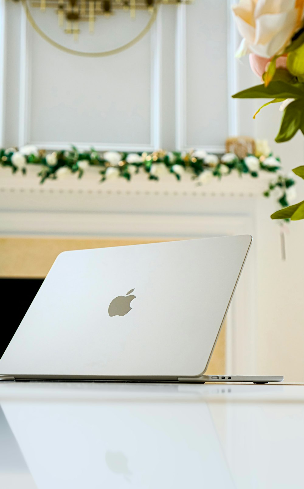 a white laptop sitting on top of a white table