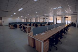 an empty office space with desks and chairs