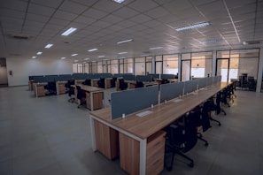 an empty office space with desks and chairs