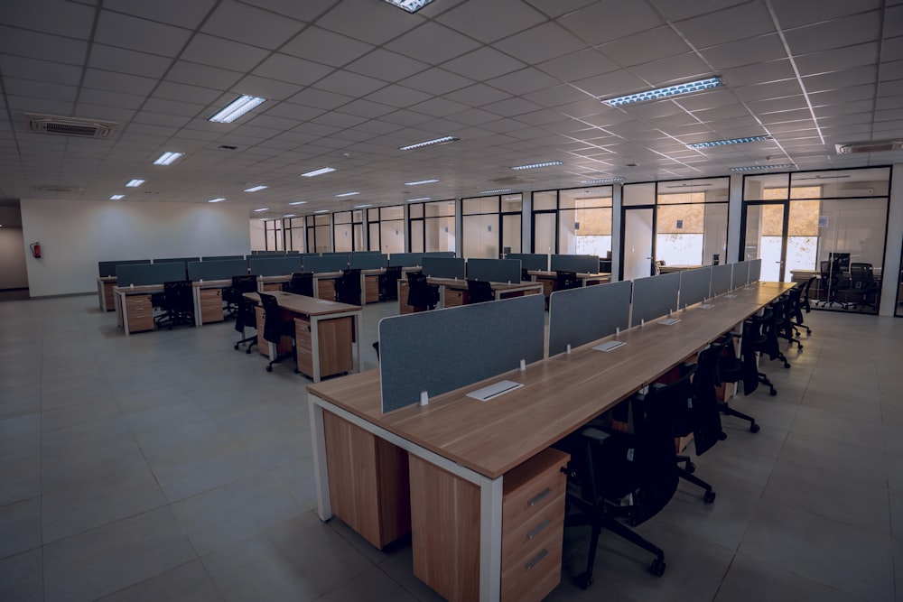 an empty office space with desks and chairs