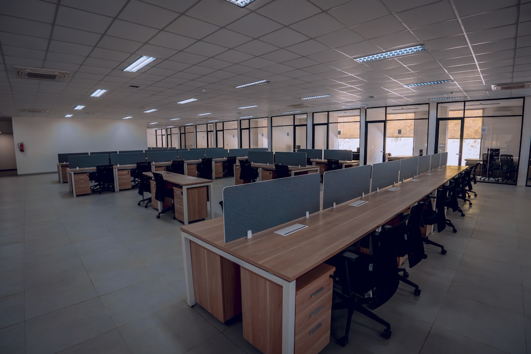 an empty office space with desks and chairs,