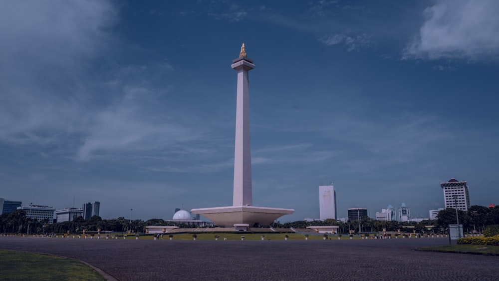 a tall white monument with a clock on top of it