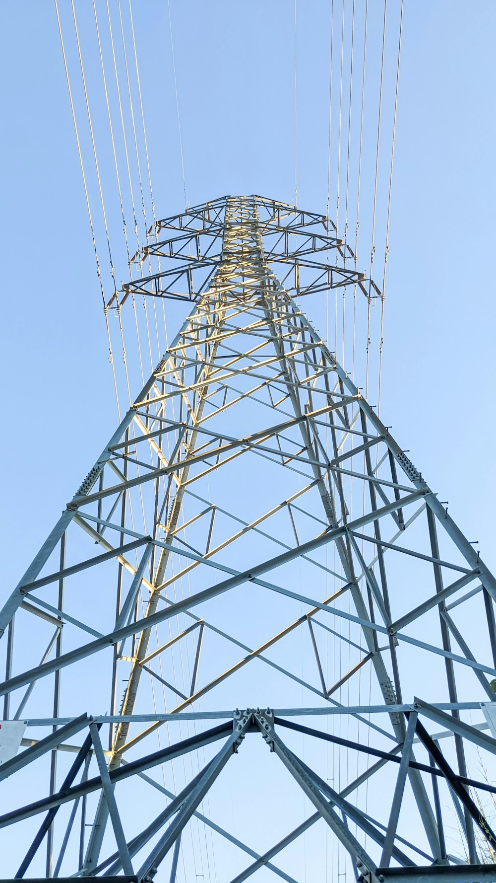 a high voltage power line with a blue sky in the background