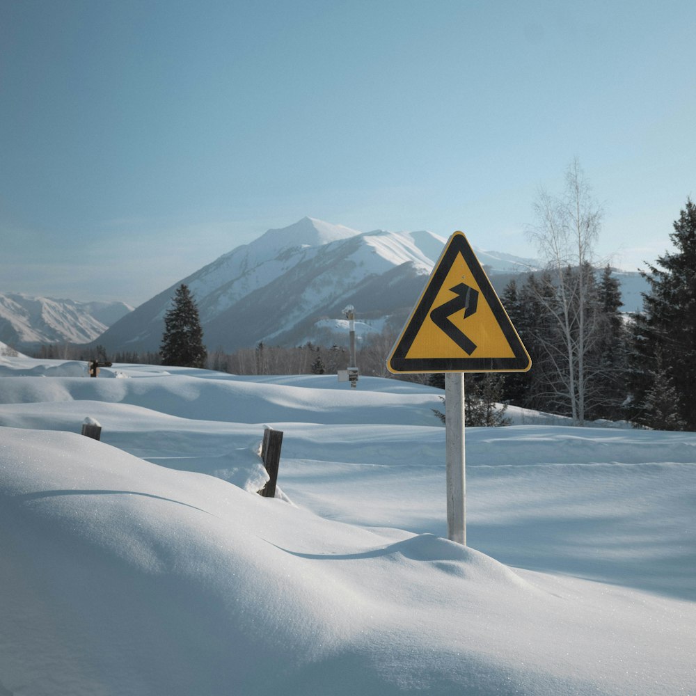 a road sign in the middle of a snow covered field