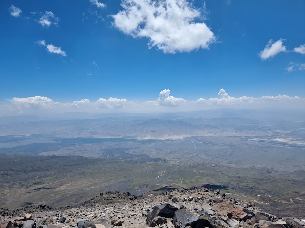 a view of a rocky mountain with a blue sky in the background