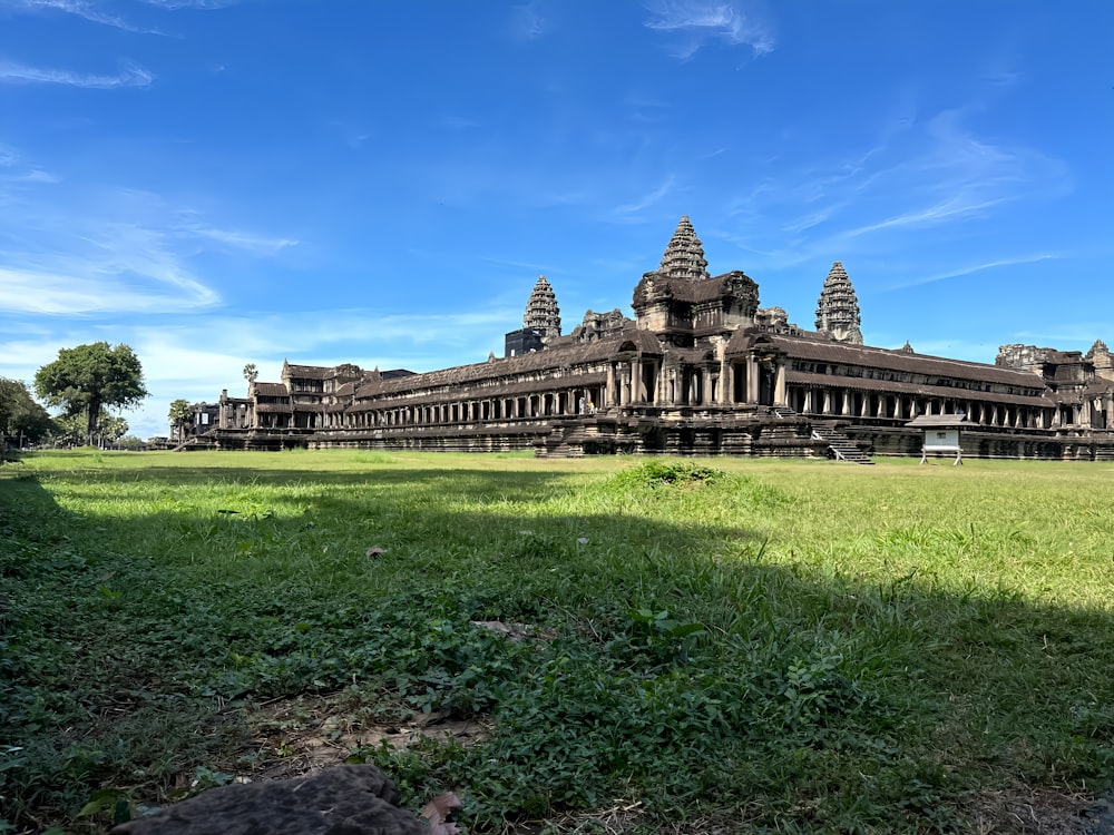 a large building sitting on top of a lush green field