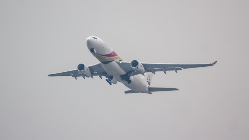 a large jetliner flying through a gray sky