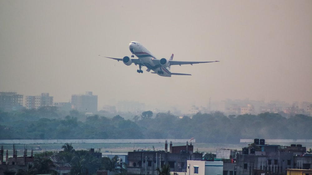 a large jetliner flying through a cloudy sky