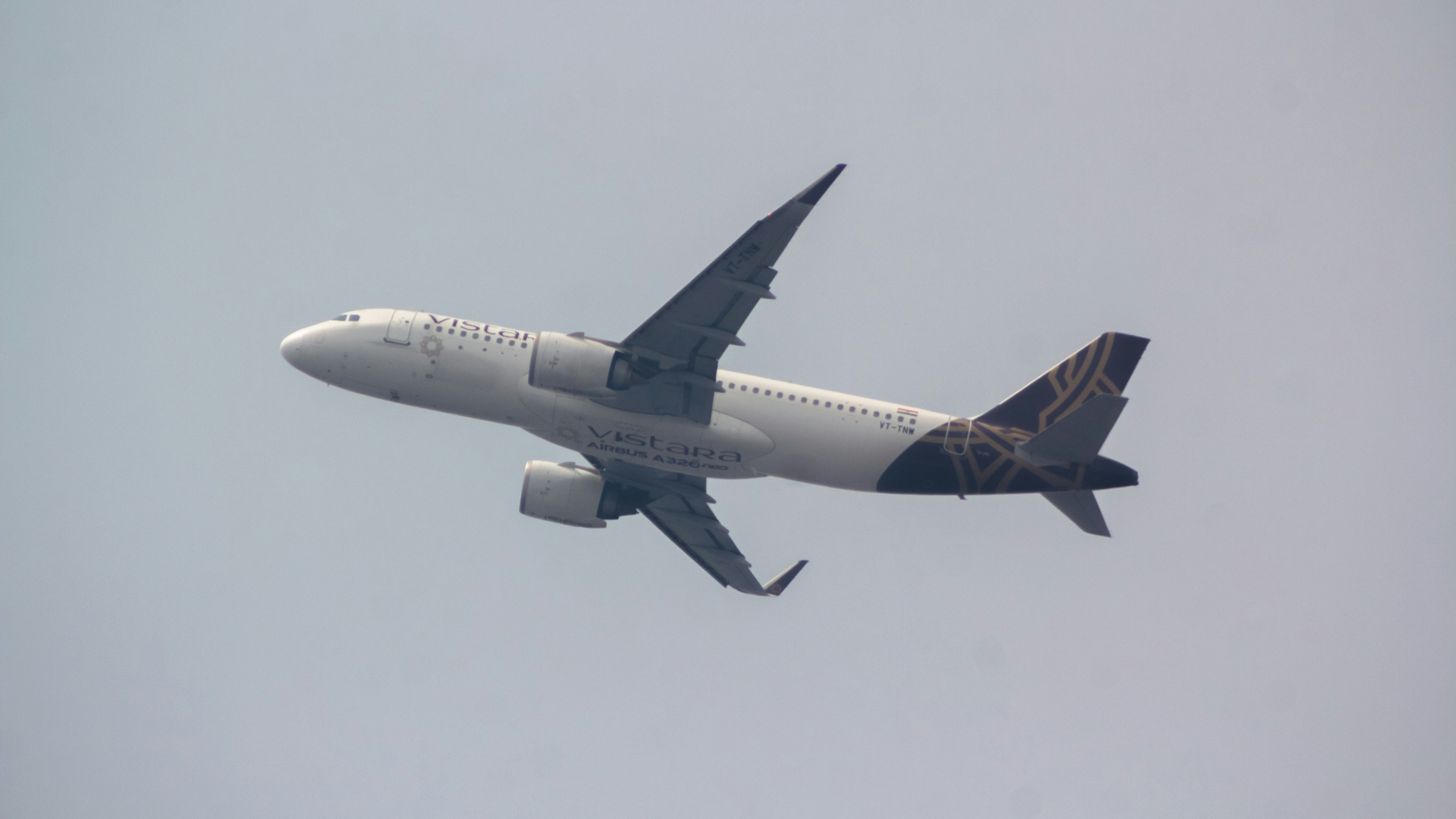 a large jetliner flying through a cloudy sky