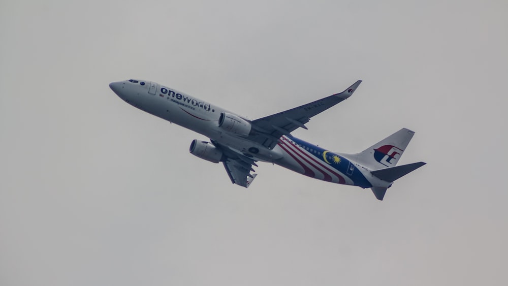 a large jetliner flying through a cloudy sky