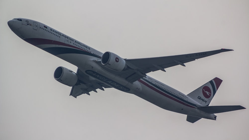 a large jetliner flying through a cloudy sky