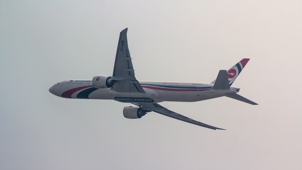 a large jetliner flying through a cloudy sky