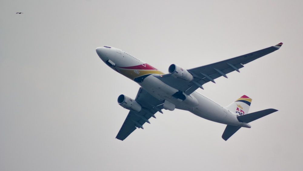 a large jetliner flying through a cloudy sky