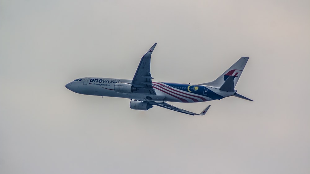 a large jetliner flying through a cloudy sky