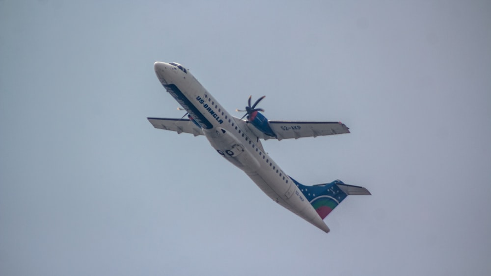 a large passenger jet flying through a cloudy sky