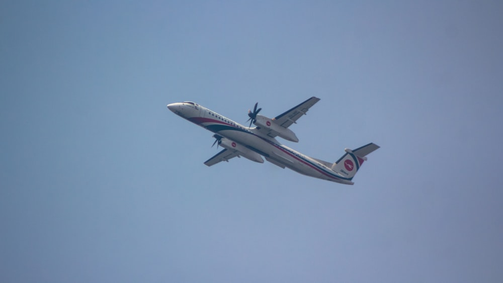 a large jetliner flying through a blue sky