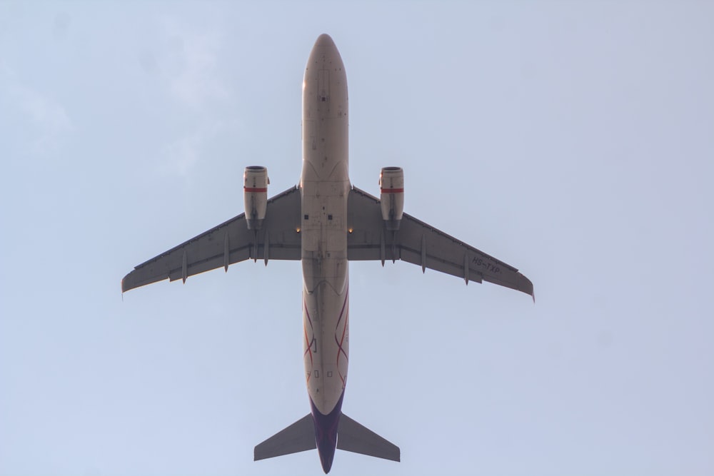 a large jetliner flying through a blue sky