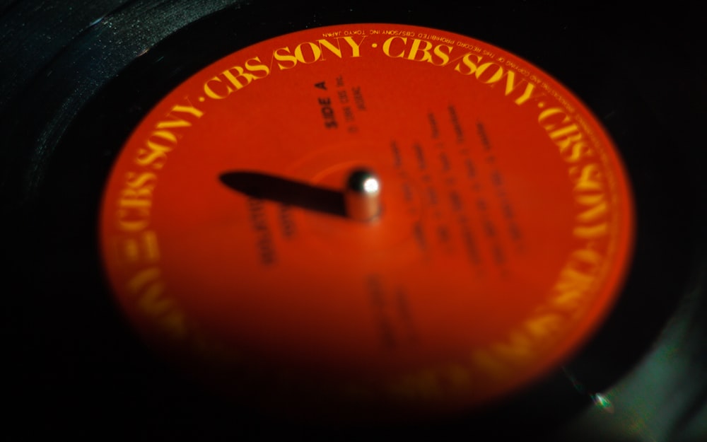 a close up of an orange label on a record