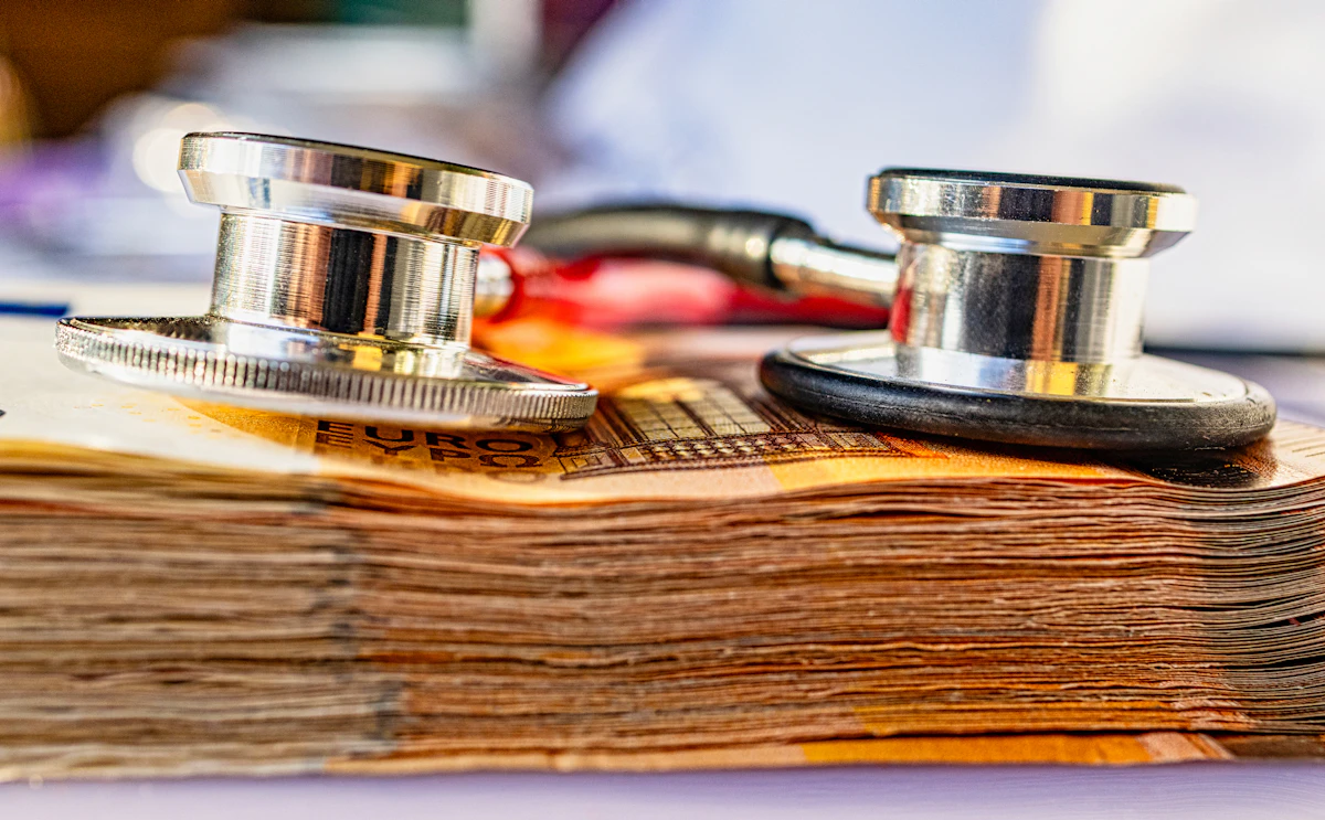 A stethoscope resting on a stack of money, representing the real cost of a physiotherapy consultation in Sydney