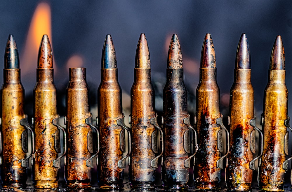 a bunch of bullet shells lined up in a row