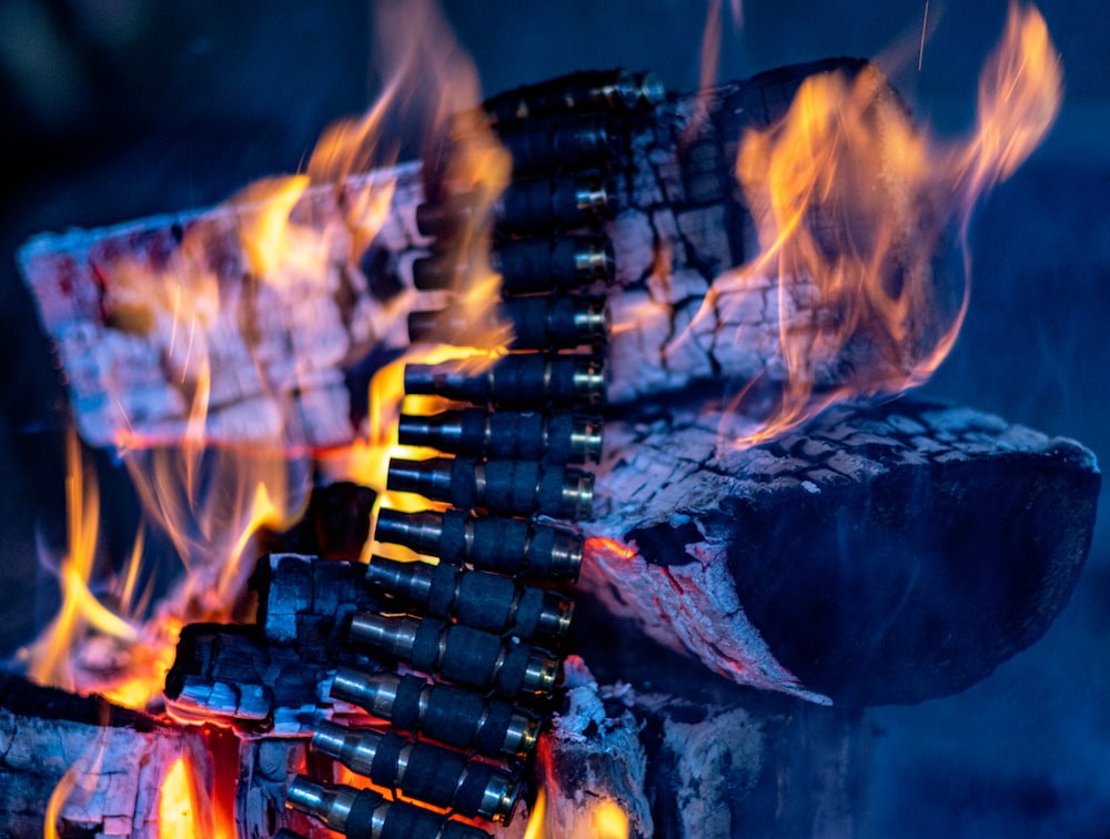 a pile of wine bottles sitting on top of a fire