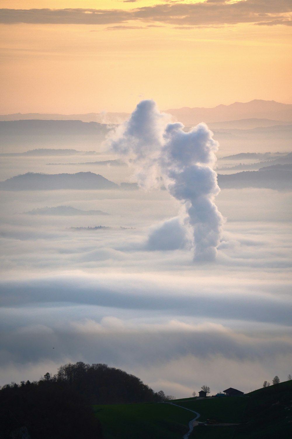 a large plume of smoke coming out of the top of a mountain