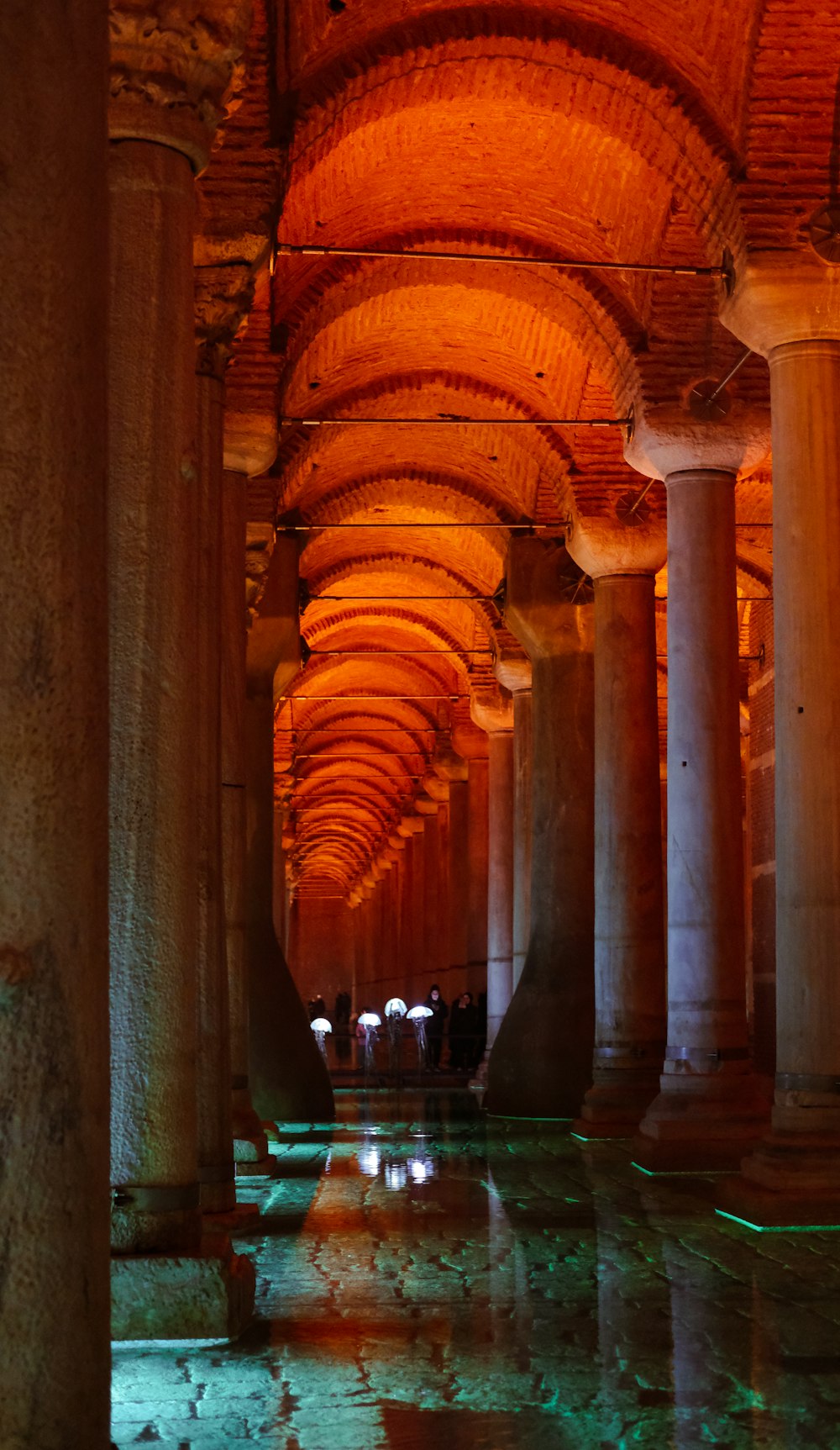 a group of people walking down a long hallway