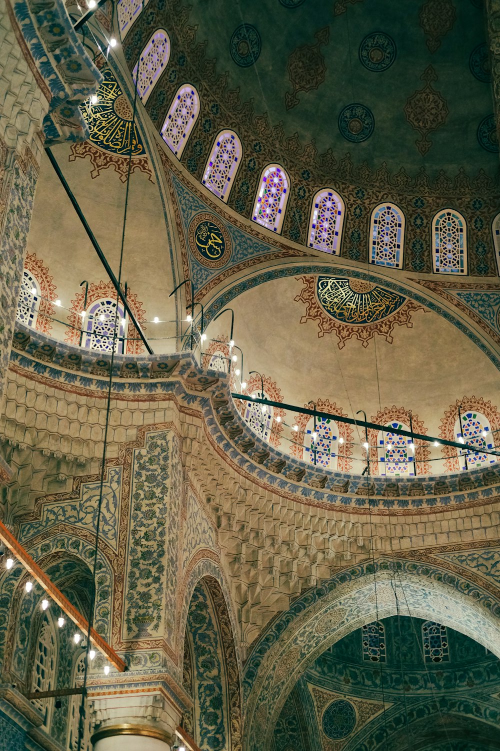 the ceiling of a large building with many windows