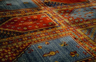 a close up of a colorful rug with many designs