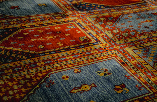 Hand-knotted patterned rug in warm reds and blues